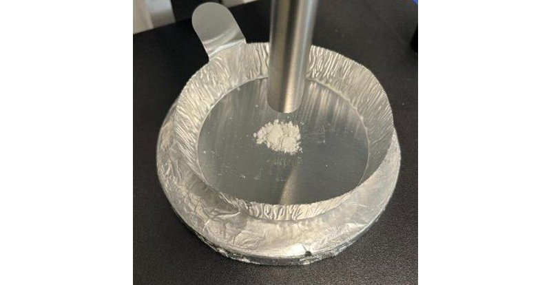 Precipitate recovered from the reaction and mounted on a BAC151B probe holder for Raman analysis.